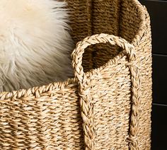 a woven basket with a white pillow in it