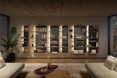 a living room filled with lots of furniture next to a wall mounted book shelf covered in books