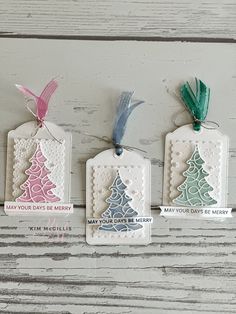 three tags with christmas trees on them