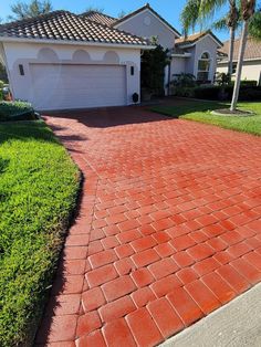 a red brick driveway in front of a house