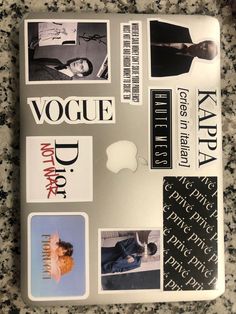 an apple laptop with various stickers on it