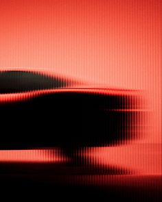 a black and red car is shown in the image with blurry lines on it