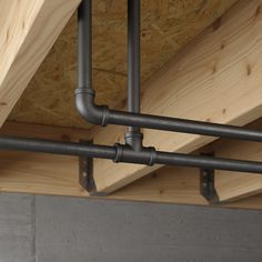 two metal pipes are connected to the ceiling