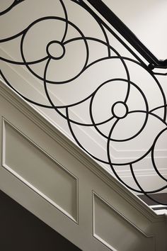 an ornate design on the ceiling above a doorway in a house with white walls and black trim