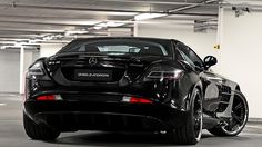 a black mercedes sports car parked in a parking garage