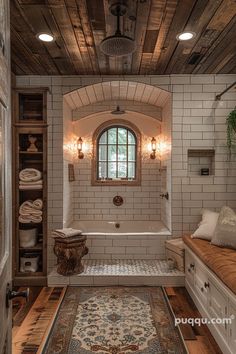 a bathroom with a tub, sink and rug on the floor in front of it