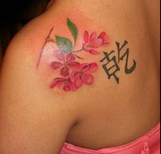 a woman's breast with flowers and the chinese character jnj on it