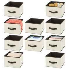 six white drawers with black handles on each side and one open drawer in the middle