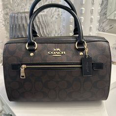 Coach Never Used, Excellent Condition. Coated Signature Canvas And Leather Bag. I Prefer A Larger Bag So I Will Part With It. No Dust Bag, Tags (I Cut Off Before Changing My Mind) Or Extra Strap. Stored In A Climate Controlled, Smoke Free House. Gold Tone Hardware (Not Tarnished Or Not Scratched). No Wear Or Tears Anywhere. See Last Photo For Size And Description. Coach Rowan Satchel, Leather Canvas Bag, Coach Rowan, Brown Satchel, Canvas Leather Bag, Girly Bags, Bags Coach, Signature Canvas, Michael Kors Hamilton