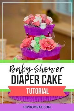 a baby shower diaper cake sitting on top of a table with the words, baby shower