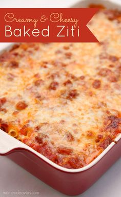 a red casserole dish with cheese and baked zitti in it on a white surface