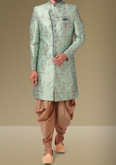 Ready-Made Sherwani With Trouser. Jacquard Brocade Fabric Top. Art Dupion Peshawari Ready Made Trouser. Crafted in Chinese Collar Neck, and Full Sleeve. Satin Lining with Plain Work. High-Quality Matching Buttons. Please Note: The footwear shown in the picture is for presentation and photography purpose only. Color: There might be slight color variation due to lightings and flashes while photo shooting. The color may also vary because of different screen resolutions. Wash Care: Dry Clean Only. Designer Brocade Salwar Kameez With Traditional Drape, Traditional Fitted Raw Silk Sherwani, Fitted Pista Green Banarasi Silk Sets, Fitted Banarasi Silk Set In Pista Green, Formal Long Sleeve Unstitched Suit For Navratri, Brocade Kurta With Dupatta For Transitional Season, Bollywood Style Ceremonial Pista Green Kurta, Ceremonial Bollywood Style Pista Green Kurta, Semi-stitched Art Silk Sherwani With Cutdana