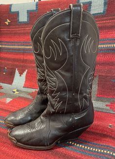 "From Blackbird Vintage of Sedona, Arizona  This is a great pair of authentic Vintage Men's Black Cowboy boots, size 8 D. (Most likely would also fit a ladies 9.5) 12\" tall.  They feature silver metal tips, a very unique heel and are made in Mexico, circa 1950s. measurements: Height: 14 inches, inclusive of 2 3/8 inch heel Heel to toe: 10.5 inches width, widest part of sole: 3 7/8 inches circumference around top of calf: 15\" They are quite distressed and very worn in, with many scuffs and nick Vintage Snip Toe Boots For Fall, Vintage Black Winter Boots, Vintage Western Boots With Pointed Toe, Fitted Vintage Black Boots, Vintage Brown Boots For Western-themed Events, Vintage Boots With Leather Lining And Round Toe, Vintage Pointed Toe Boots For Western-themed Events, Vintage Pointed Toe Boots For Western Events, Fitted Vintage Boots With Leather Lining