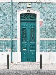 a large green door on the side of a building