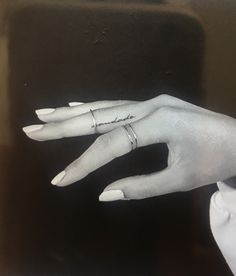 a person's hand with a ring on it