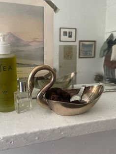 a bathroom counter with a sink, mirror and soap dispenser on it