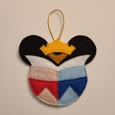 a mickey mouse ornament hanging on a wall