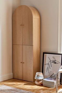 a wooden cabinet sitting in the corner of a room