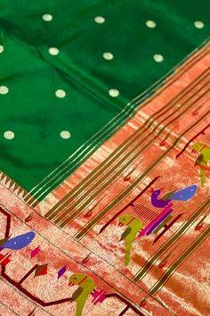 This exquisite regal paithani saree is handwoven in deep green color. Traditional gold zari coin buttis adorn the body while the golden zari border is decorated with handwoven brocade border. The elaborate pallu is woven with colorful peacocks along with winding vines and flowers. The saree comes with plain blouse with matching borders. Approximate Length 6.5 mtrs (inclusive of blouse length)Height - 48- 52" Approximate weight - 1.8 lbs Saree comes with fall and picot done. Blouse piece is cut. Festive Green Paithani Silk Pre-draped Saree, Festive Gold Paithani Silk Pre-draped Saree, Gold Paithani Silk Pre-draped Saree, Multicolor Paithani Silk Handloom Pre-draped Saree, Luxury Multicolor Paithani Silk Pre-draped Saree, Paithani Silk Saree, Vines And Flowers, Paithani Saree, Plain Blouse