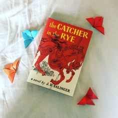 the catcher in the rye by j d salinger and origami birds on a bed