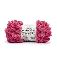 a pink ball of yarn with the words bernat all wool on it's side