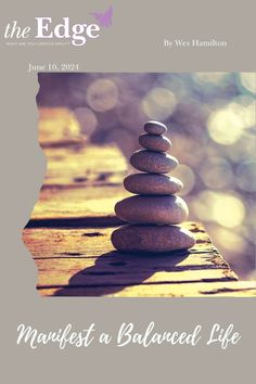 a stack of rocks sitting on top of a wooden table next to the edge magazine cover