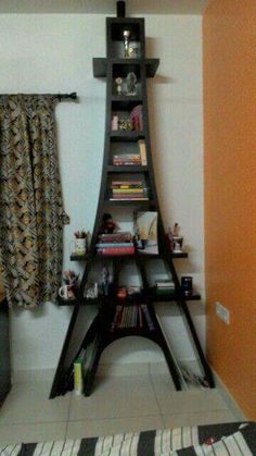 a living room with a book shelf in the corner