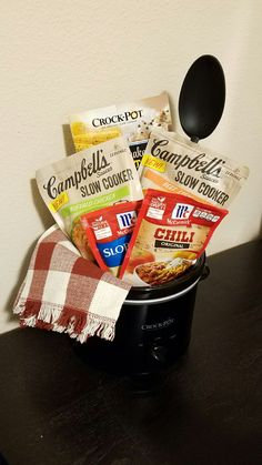 a black crock pot filled with food and a spoon