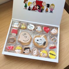 an open box of cookies decorated with cartoon characters