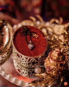 a red box with a cross on it surrounded by other jewelry