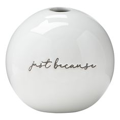 a white vase with the word just because written in cursive writing on it