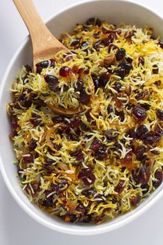 a white bowl filled with rice and raisins