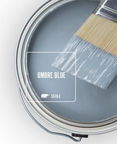 a paint can with a brush in it and the words ombre blue on it