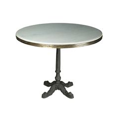 a round metal table with an iron base