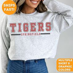 Stay cozy and show your team pride with our Custom Team Mascot Sweatshirt! Perfect for game days, casual outings, or lounging at home Crafted from high-quality, ultra-soft fabric, this sweatshirt offers unbeatable comfort and warmth. It's customizable with your choice of colors and team/city name, making it a unique and personal piece of fan gear. Whether you're cheering from the stands or representing your team around town, this versatile sweatshirt is a stylish way to display your loyalty. It' Baseball Season Crew Neck Sweatshirt With School Spirit, School Spirit Crew Neck Sweatshirt For Baseball Season, School Spirit Sweatshirt With Crew Neck For Baseball Season, Crew Neck Sweatshirt For Baseball Season With School Spirit, School Spirit Graphic Sweatshirt For Baseball Season, School Spirit Graphic Print Sweatshirt For Baseball Season, High School Mascot Shirt Ideas, Varsity Long Sleeve T-shirt For Game Day, College Fan Apparel Hoodie With Letter Print