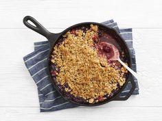 a skillet filled with crumbled food on top of a blue and white towel