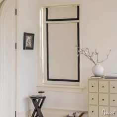 an empty room with white walls and black trim