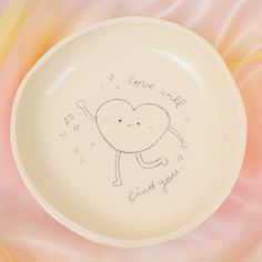 a white plate with a drawing of a heart on the side and words that say i love you