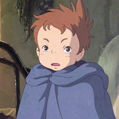 a young boy wrapped in a blanket looking at the camera with an angry look on his face