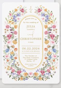 a wedding card with flowers in the middle and gold foil on it, featuring an ornate frame