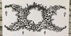 an artistic black and white drawing of flowers on a white background with diamond shapes in the middle