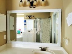 a bathroom with a sink, mirror and lights