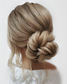 a woman with blonde hair in a low bun