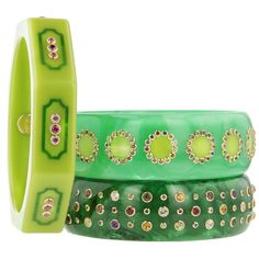 This eye-catching bright green bakelite bangle, from the Mark Davis Collector Line, is detailed with inlaid frames of darker green bakelite featuring concave corners. All eight sides of the octagonal bangle have been inlaid and mounted with a rhodolite garnet flanked by pink sapphires. All stones have been bezel set in 18k yellow gold. This bangle has a very architectural quality and brings to mind Hollywood Regency or some of the Palm Beach projects by John Volk. Metal 18-Karat Yellow Gold (Au7 Luxury Green Oval Bangle, W.kruk Jewelry, Luxury Green Carved Bangle, Beach Projects, Bakelite Bangles, Green Frame, Rhodolite Garnet, Gorgeous Jewelry, Hollywood Regency