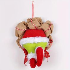 a red and green christmas ornament hanging on a wall