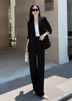 Elevate your wardrobe with our Estelle Double Breasted Blazer Wide Pants Suit. This two-piece set features a sophisticated and exclusive design with a double-breasted blazer and wide-leg pants. Perfect for any occasion, this black suit exudes elegance and taste. Blazer: Double Breasted closure Notched lapels Long sleeves Front flap pockets Pants Zip fly with button closure Side slant pockets Regular length - Polyester, spandex- Item #431910- Women's blazer & pants suit two-piece set SIZE INFO XS Pockets Pants, Pants Suit, Black Suit, Breasted Blazer, Wide Pants, Double Breasted Blazer, Black Suits, Dress Pant, Pocket Pants