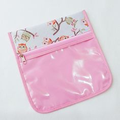 a pink pouch with an owl print on it