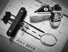 a pair of shoes and tie laying on top of a calendar