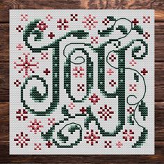 a cross stitch pattern with the word joy written in red and green letters on it