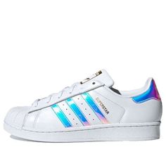 The Adidas Originals Superstar is a timeless classic that has been around since 1969. It is the first low-top basketball shoe to feature a full leather upper and rubber toe cap, which has become its signature look. It was a favorite of almost 3/4 of NBA players in the 70s and has since become a fashion staple across fashion, music, street culture, leisure and sports. The 'Iridescent Hologram' edition features a sleek white upper with a silver sole, making it the perfect combination of style and Iridescent Lace-up Sneakers For Streetwear, Sporty Iridescent Low-top Sneakers, Iridescent Sporty Sneakers For Streetwear, Sporty Iridescent Sneakers For Streetwear, Iridescent Low-top Sporty Sneakers, Iridescent Lace-up Sporty Sneakers, Sporty Iridescent High-top Sneakers, Iridescent Sneakers With Round Toe For Sports, Casual Iridescent Sneakers For Streetwear